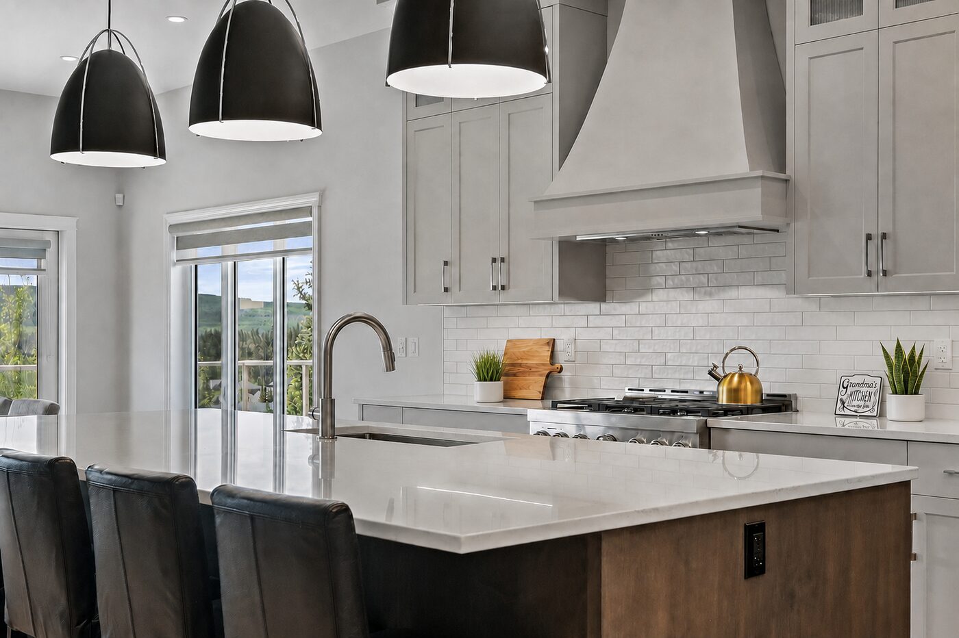 Bright contemporary kitchen with sculptural pendant lights, a generous island, and warm wood accents.